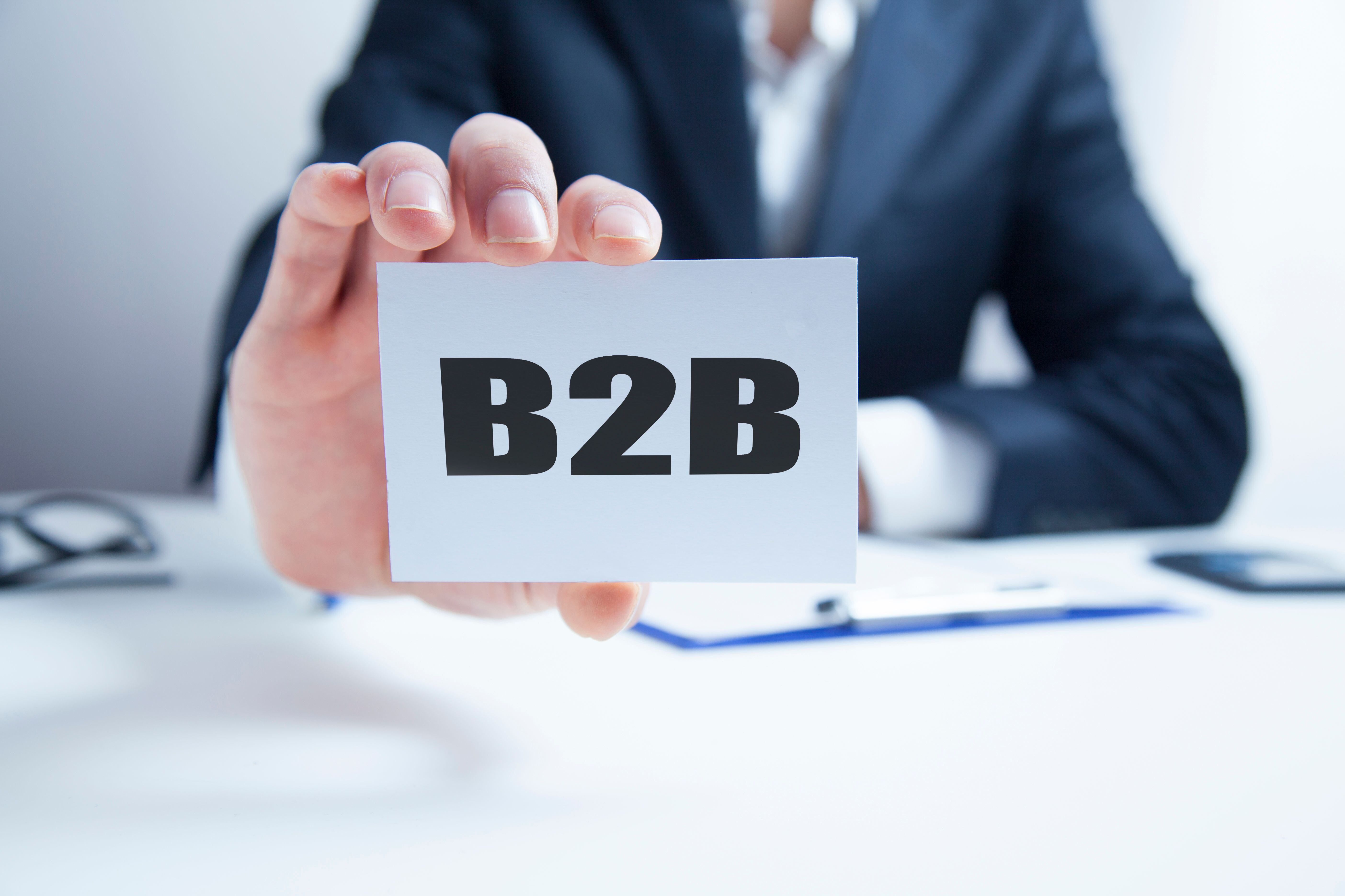 businessman-hand-card-with-inscription-b2b